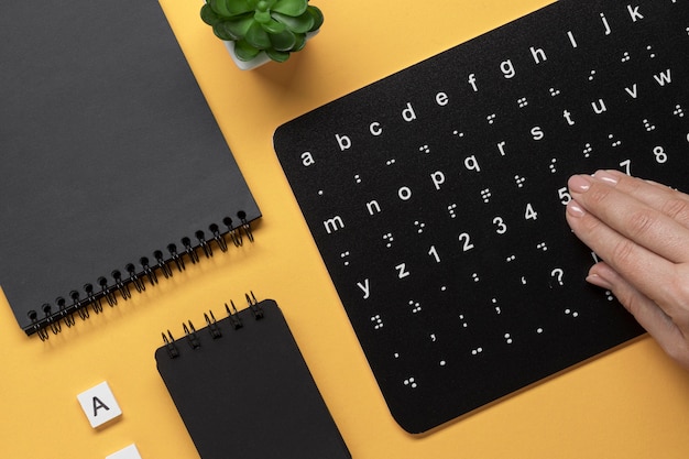 Photo hand touching braille alphabet keyboard