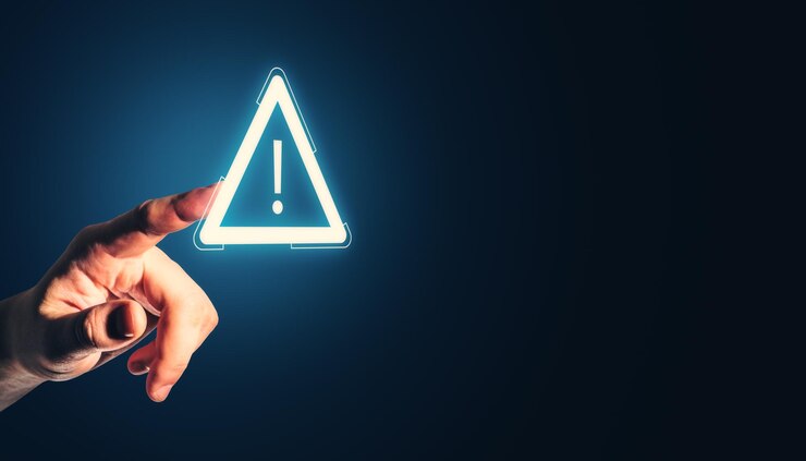Photo hand touching glowing caution symbol with exclamation mark on dark background in a technological concept