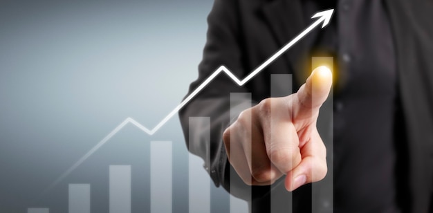 Hand touching  graphs of financial indicator and accounting market economy analysis chart