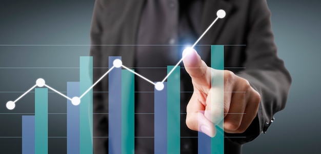 Hand touching graphs of financial indicator and accounting market economy analysis chart