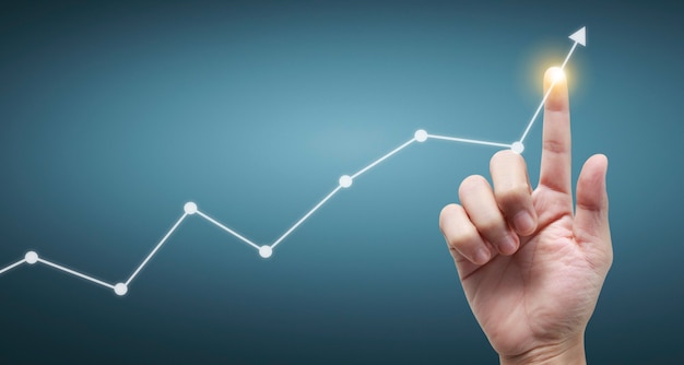 Hand touching a graphs of financial indicator and accounting market economy analysis chart