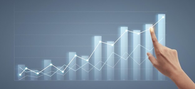 Hand touching graphs of financial indicator market analysis chart