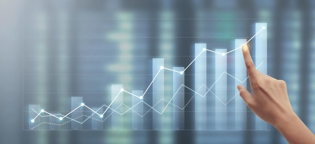 Hand touching graphs of financial indicator market analysis chart