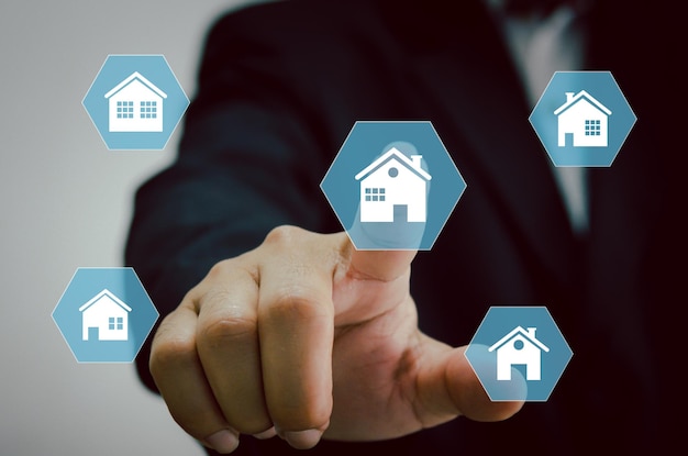 Hand touching icon house.Real estate concept business, home insurance and real estate protection. Buy and sell houses and real estate online on a virtual.