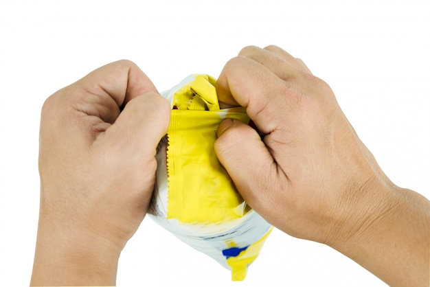 Hand trying to unwrap a pastry bag Represents the gesture during a tear the bag out using 