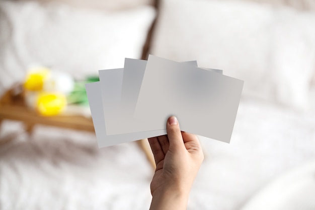 Hand of unknown person holding some empty pieces of paper