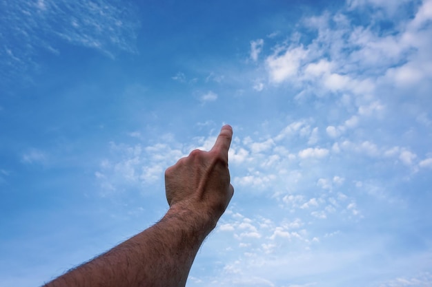 Photo hand up gesturing in the blue sky feelings and emotions