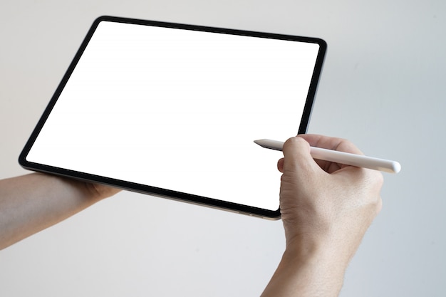 Photo hand using digital tablet pen touch blank screen. hands holding and writing on digital tablet.