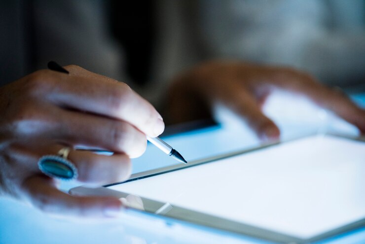Photo hand using magic pen on a tablet screen