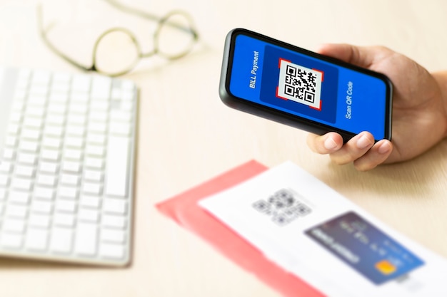 Hand using a smartphone to pay a bill