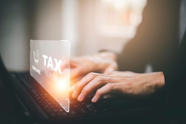 Hand using tablet with bar TAX REFUND and refund tax of duty taxation business graphs and chart being demonstrated on the screen media tablet pc and selecting tax refund