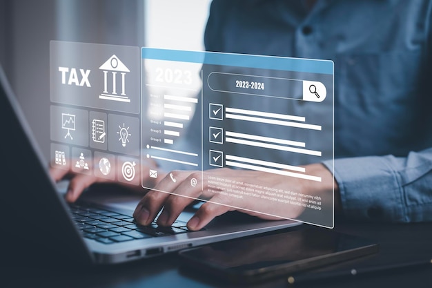 Photo hand using tablet with bar tax refund and refund tax of duty taxation business graphs and chart being demonstrated on the screen media tablet pc and selecting tax refund