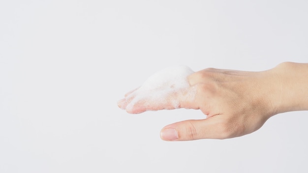 Hand washing gesture with foaming hand soap on white background.