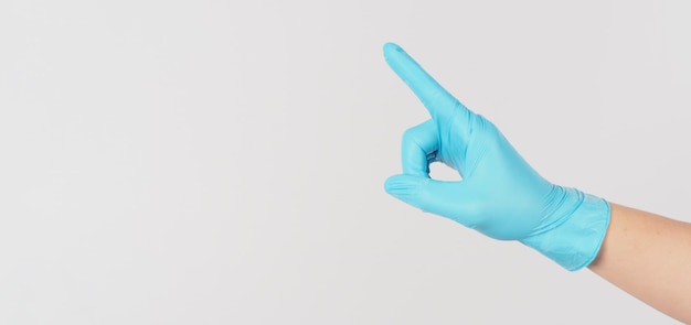 Hand wear blue medical glove and do point or touch or push gestureing on white background.