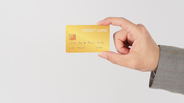 Hand wear grey suit is holding gold credit card on white background.