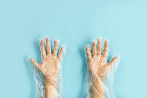 Photo hand wearing disposable plastic glove isolated on color background