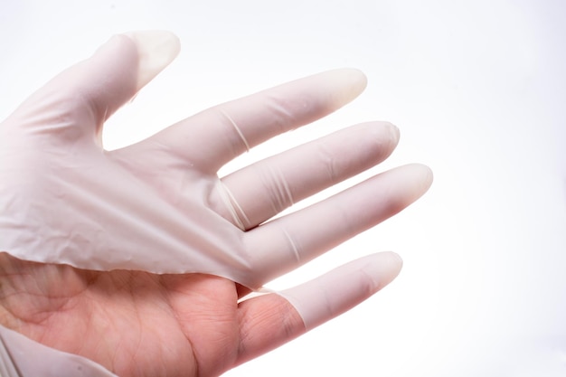 Hand wearing torn medical gloves or leak rubber gloves