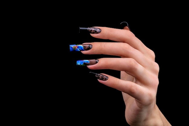 Photo hand with a beautiful manicure on a black background nail design extended nails