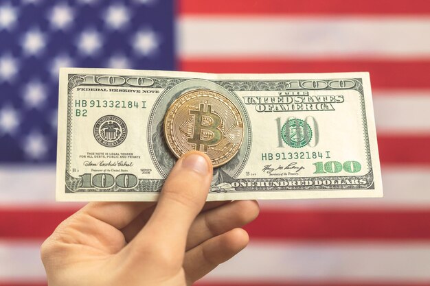 Hand with bitcoin with dollar on USA flag background. Cryptocurrency and United States of America concept photo