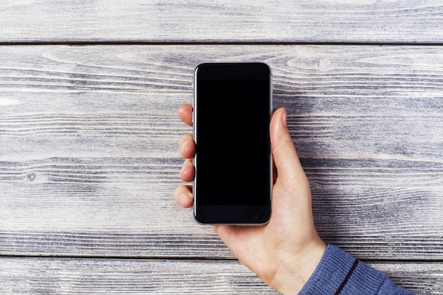 Hand with black smartphone