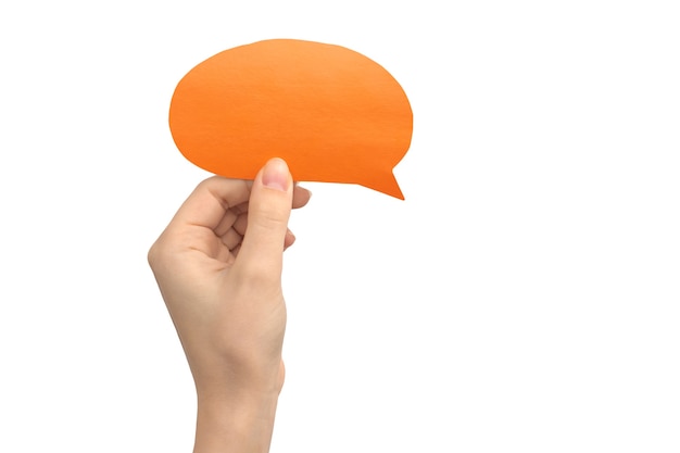 Hand with blank speech bubble in round shape, orange color, isolated on a white background. Concept of giving feedback, communication and text message. Empty cardboard mockup photo