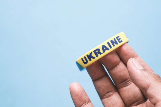 Hand with blue and yellow wristband colors of flag of Ukraine