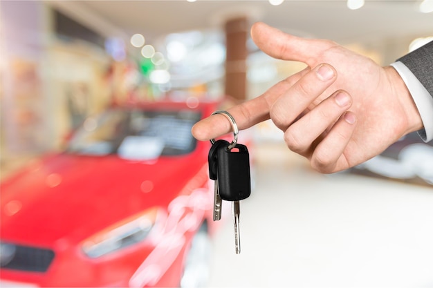 Hand with car key and remote