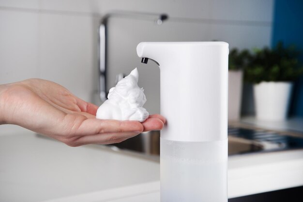 hand with foam from automatic dispenser