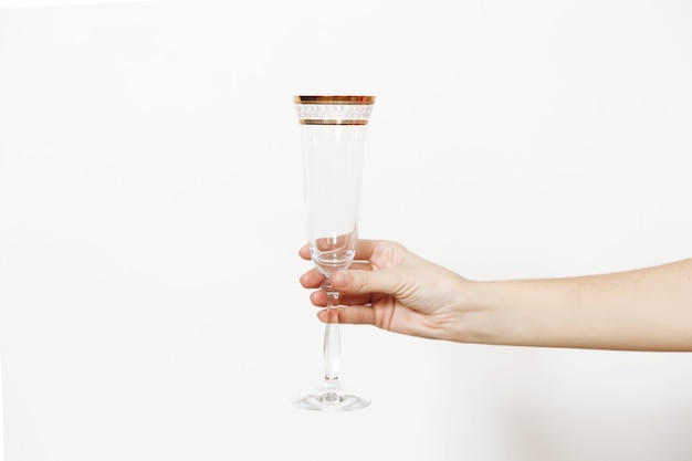 Hand with glass of champagne making toast isolated on a white background. New Year holiday 2018 concept.