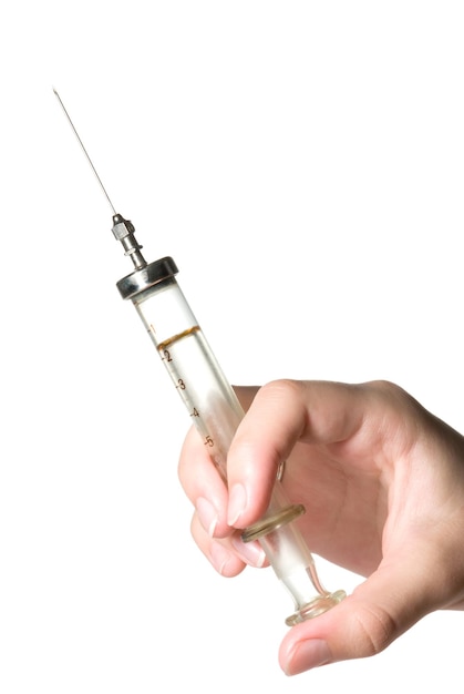 A hand with a glass syringe on white