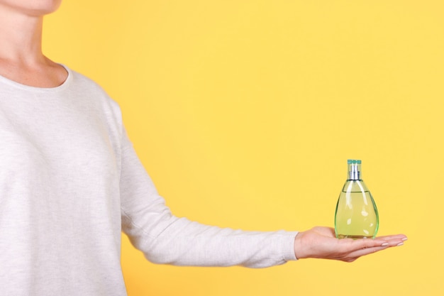 Hand with luxury perfume bottle isolated