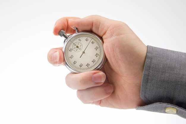 Hand with a mechanical analog stopwatch on a white background Time part precision Measurement of the speed interval