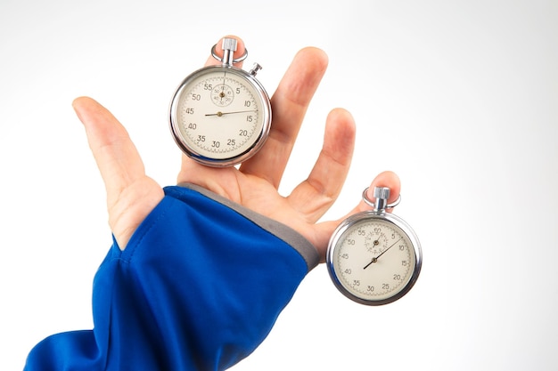 Hand with a mechanical stopwatch on a white background Time part precision Measurement of the speed interval