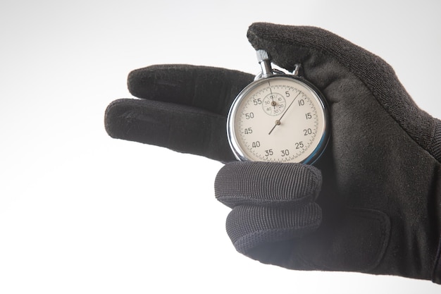 Hand with a mechanical stopwatch on a white background