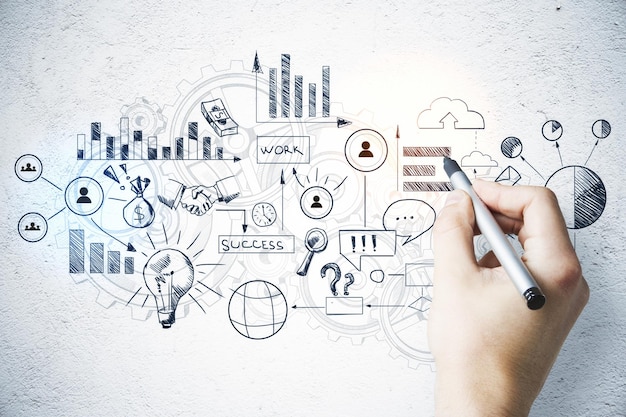 hand with pen drawing charts and business concept