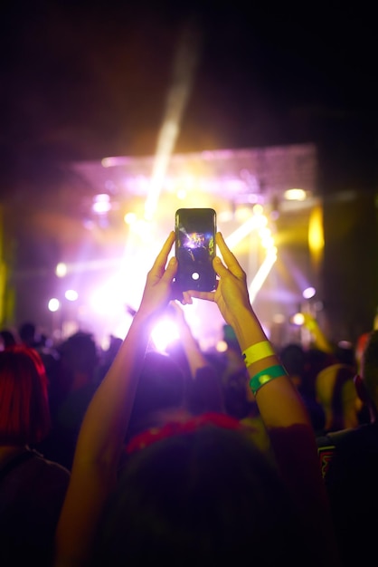 Hand with phone record live music festival People taking photographs with smart phone during concert