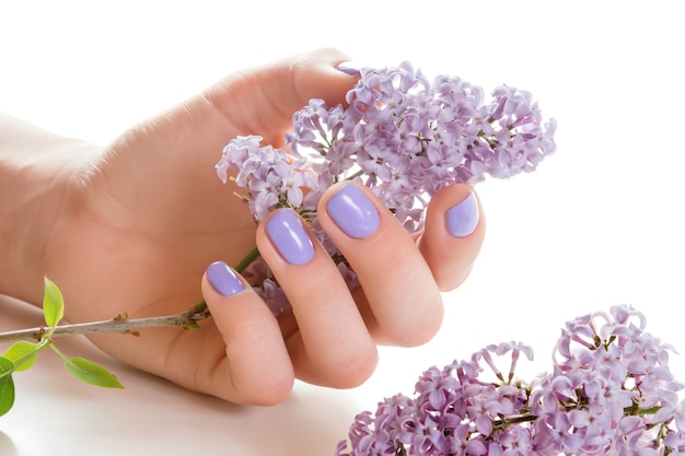 hand with purple manicure.