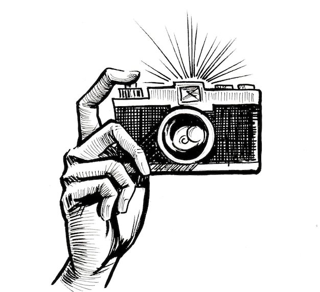 Hand with retro camera. Ink black and white drawing