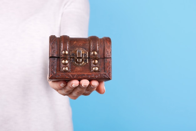 Hand with small wooden chest isolated