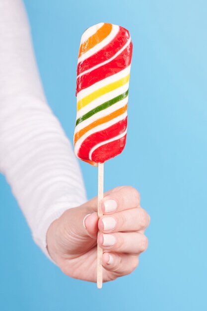 Hand with striped candy cane isolated