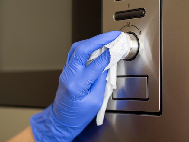 Photo hand with surgical glove sanitizing surface