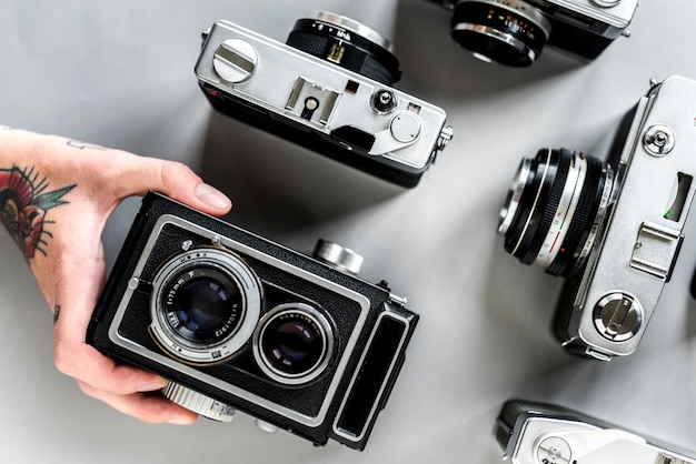 Photo hand with tattoo holding a camera