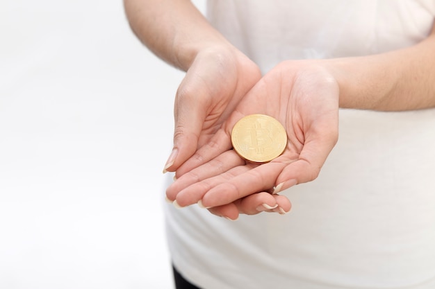 hand of woman holding bitcoin