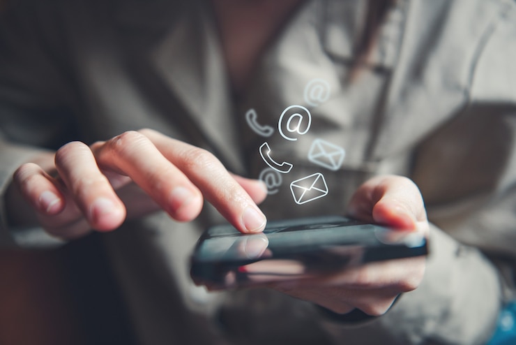 Hand of woman holding mobile smartphone with contact us