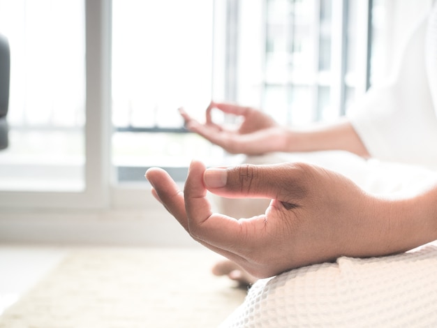Photo hand of a woman meditating yoga in room