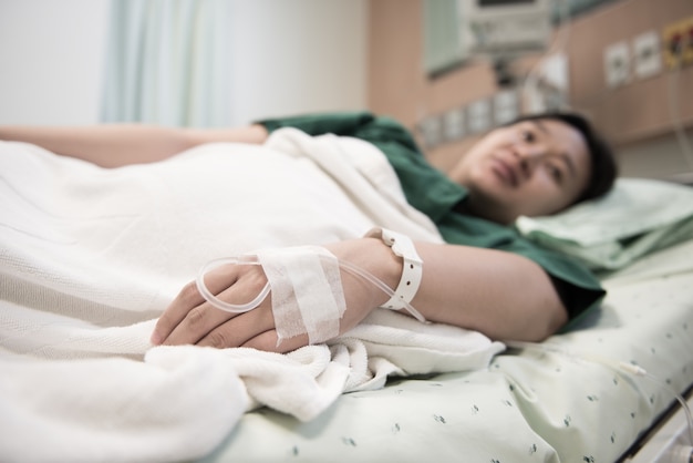 hand of Woman patient admitted to the hospital with saline intravenous (iv)