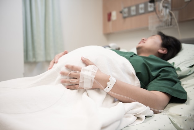 hand of Woman patient admitted to the hospital with saline intravenous (iv)