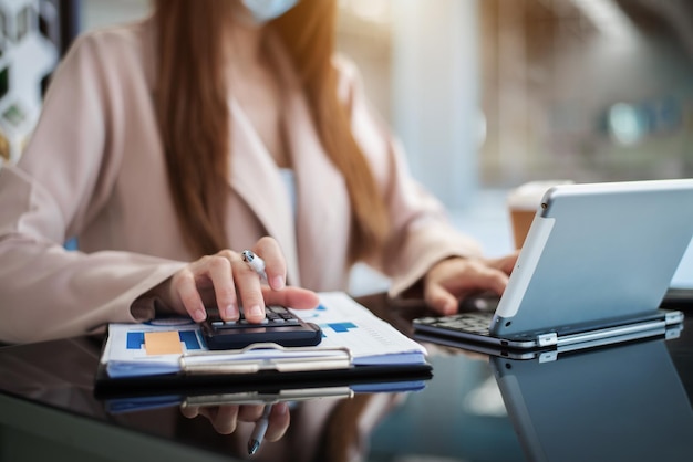 Hand women doing finances and calculate on desk about cost at home office