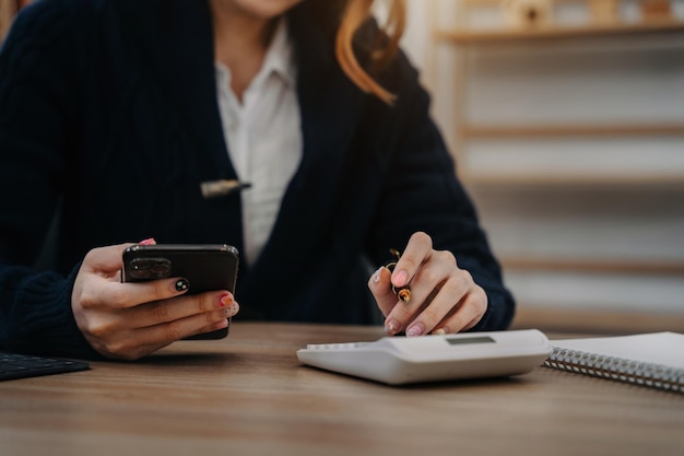 Hand women doing finances and calculate on desk about cost at office