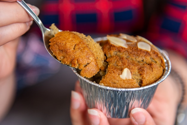 Hand women with banana cupcake in spoon